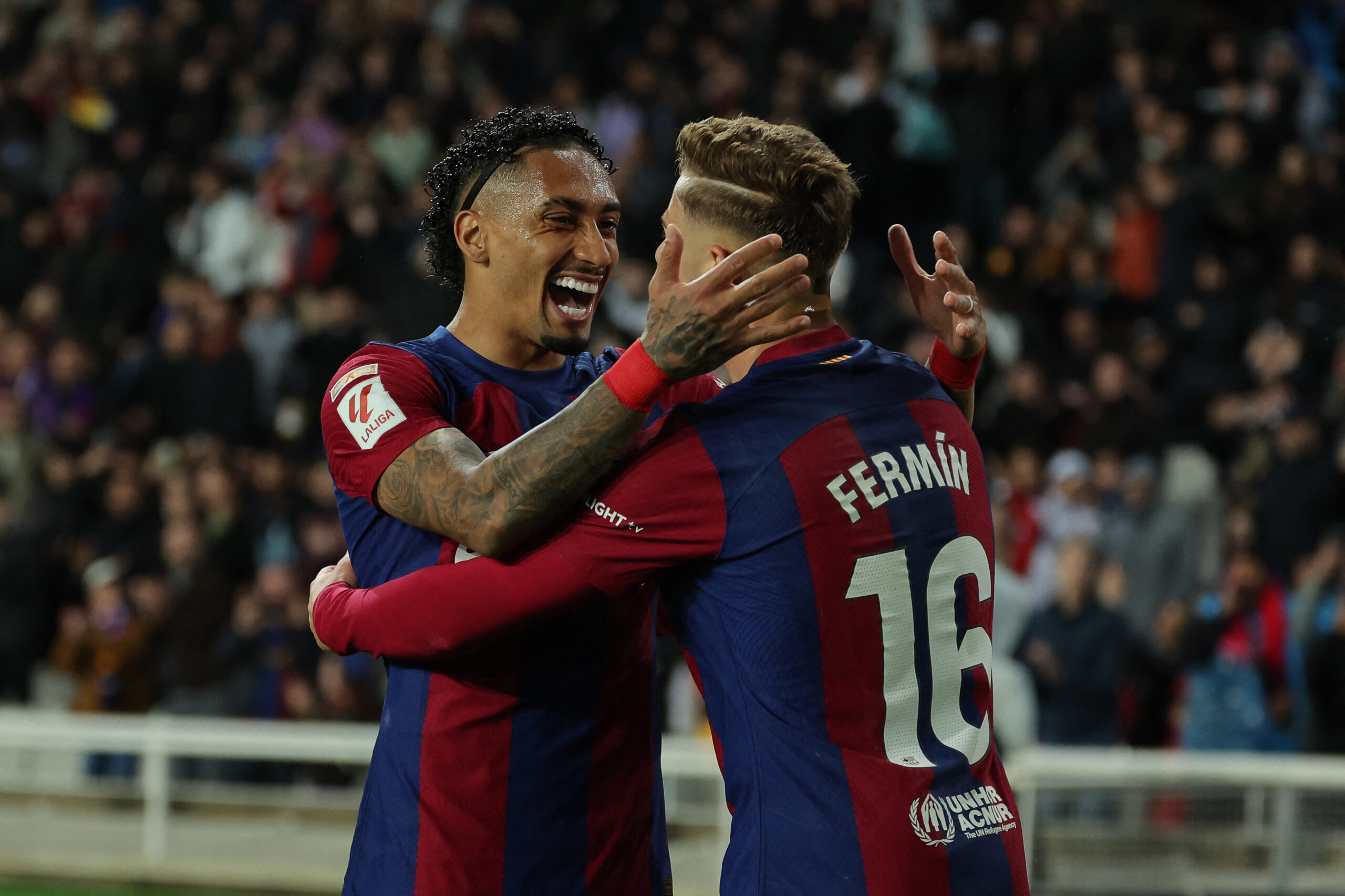 Barcelona's Spanish midfielder #16 Fermin Lopez celebrates with Barcelona's Brazilian forward #11 Raphinha after scoring his team's first goal during the Spanish league football match between FC Barcelona and Valencia CF at the Estadi Olimpic Lluis Companys in Barcelona on April 29, 2024.