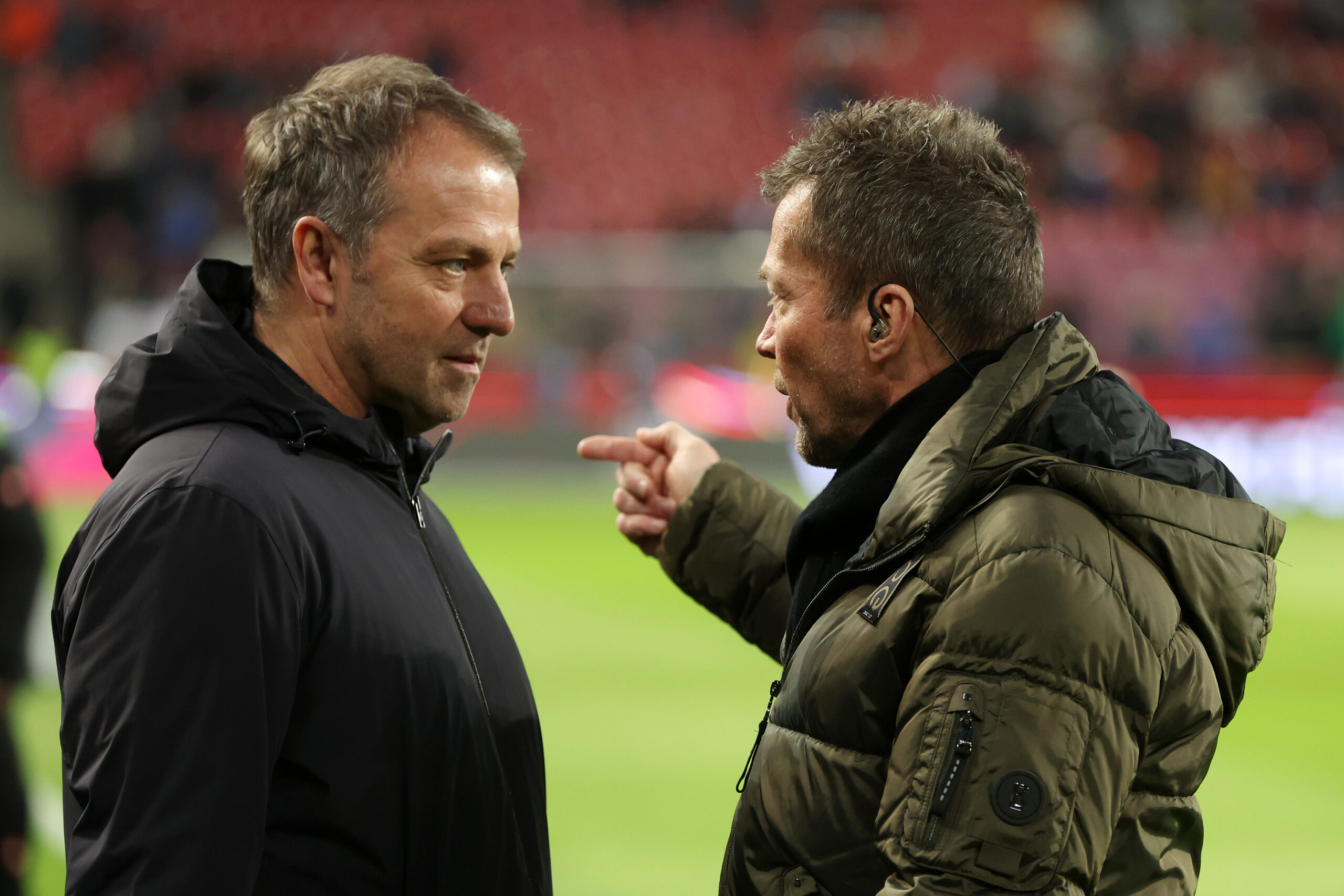 COLOGNE, GERMANY - MARCH 28: Hansi Flick, Head Coach of Germany speaks to former Germany player Lothar Matthaus prior to the international friendly match between Germany and Belgium at RheinEnergieStadion on March 28, 2023 in Cologne, Germany.