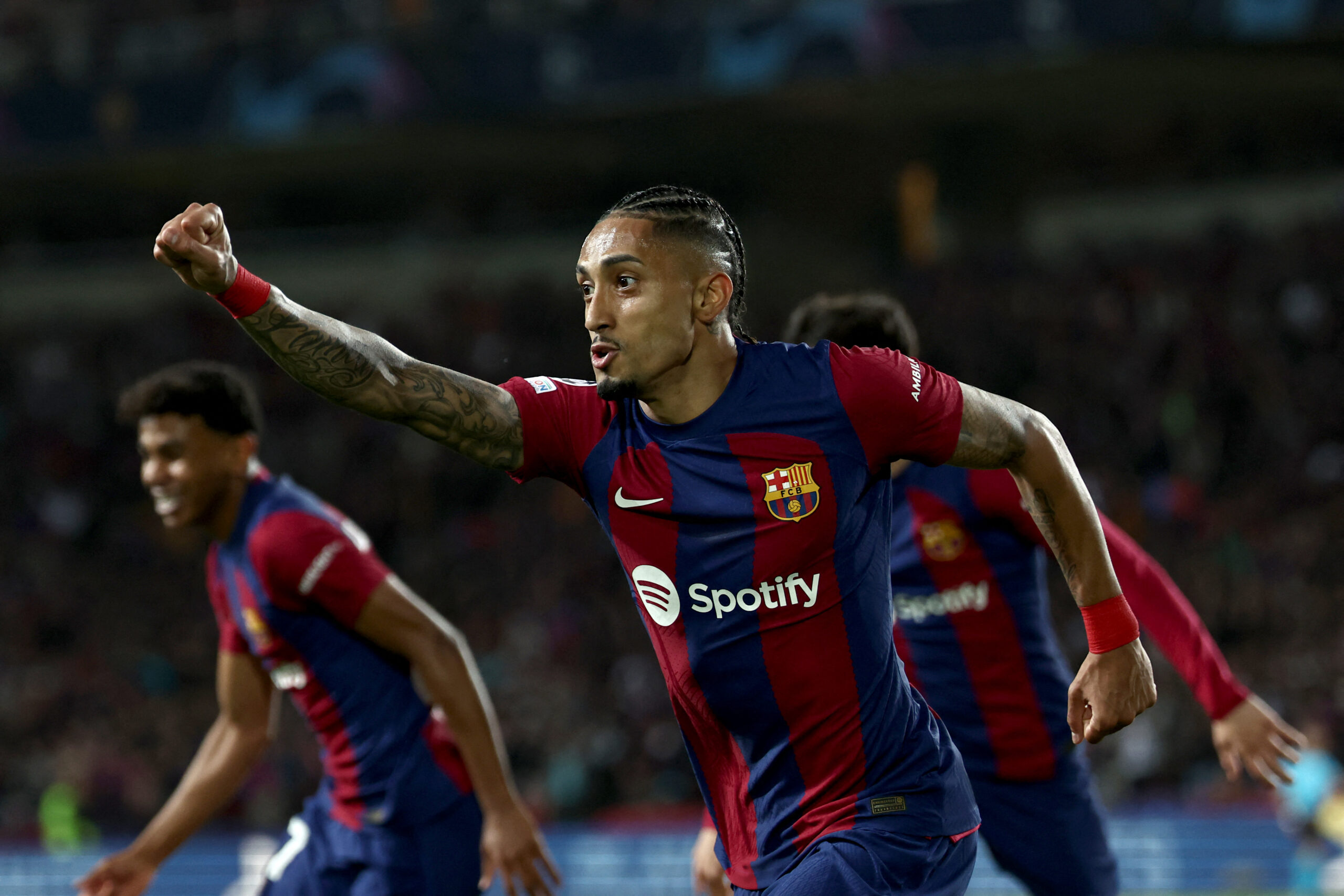 Barcelona's Brazilian forward #11 Raphinha celebrates after scoring his team's first goal during the UEFA Champions League quarter-final second leg football match between FC Barcelona and Paris SG at the Estadi Olimpic Lluis Companys in Barcelona on April 16, 2024.