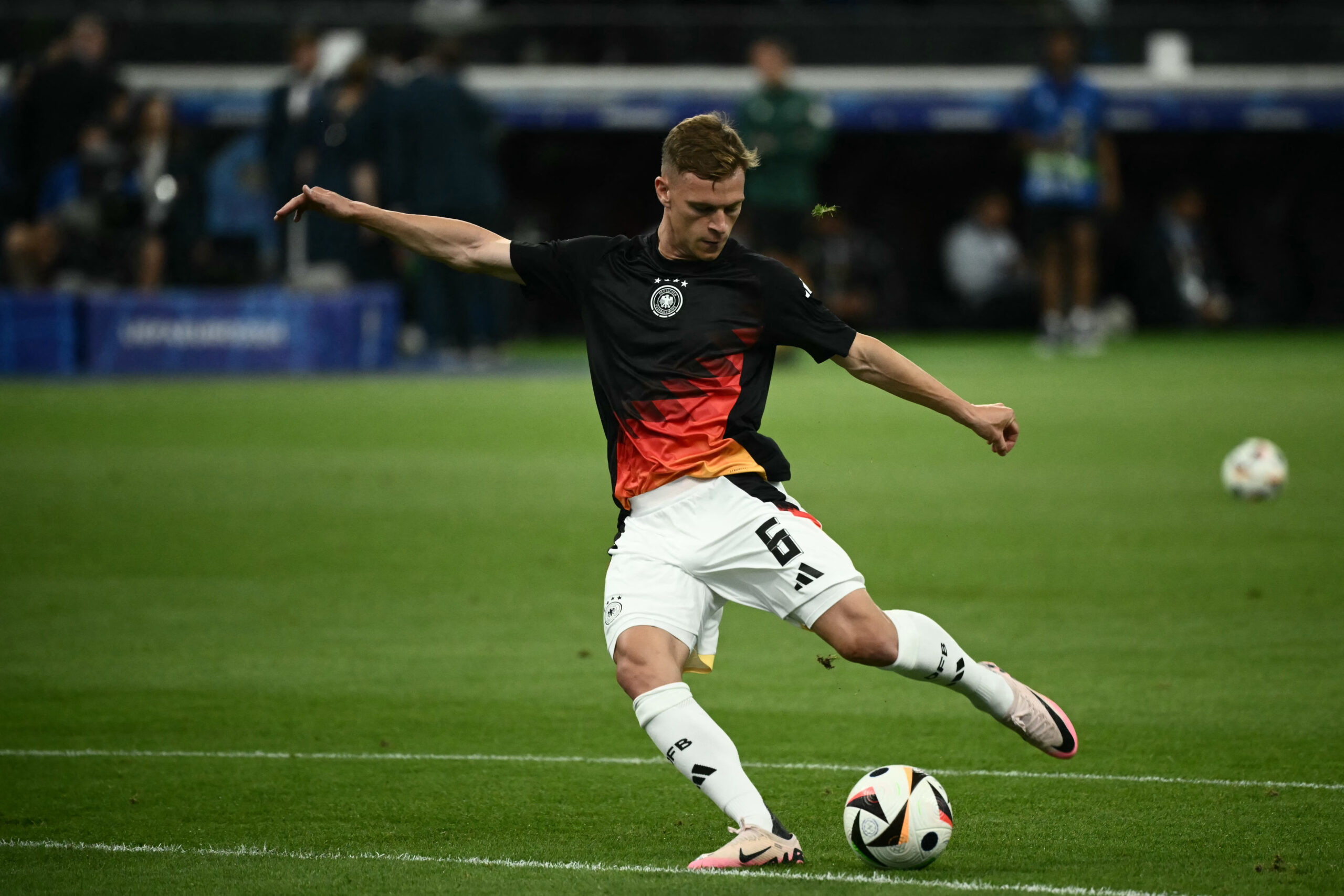 Germany's defender #06 Joshua Kimmich warms up prior the UEFA Euro 2024 Group A football match between Switzerland and Germany at the Frankfurt Arena in Frankfurt am Main on June 23, 2024.