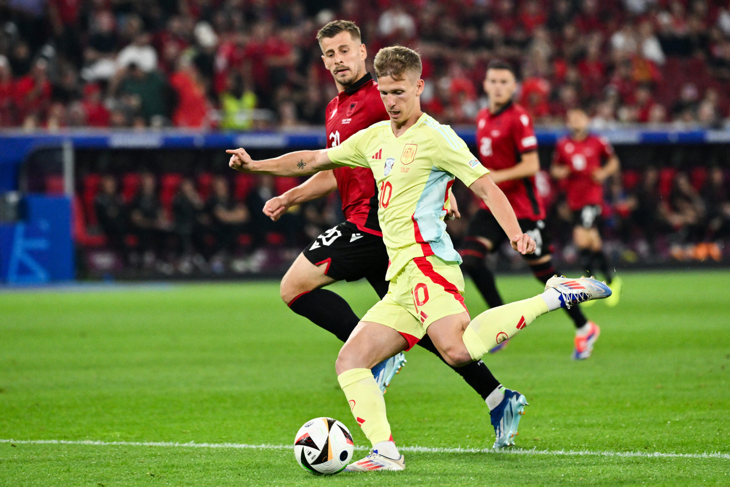 Albania's midfielder #20 Ylber Ramadani (Rear) and Spain's forward #10 Daniel Olmo fight for the ball during the UEFA Euro 2024 Group B football match between Albania and Spain at the Duesseldorf Arena in Duesseldorf on June 24, 2024.