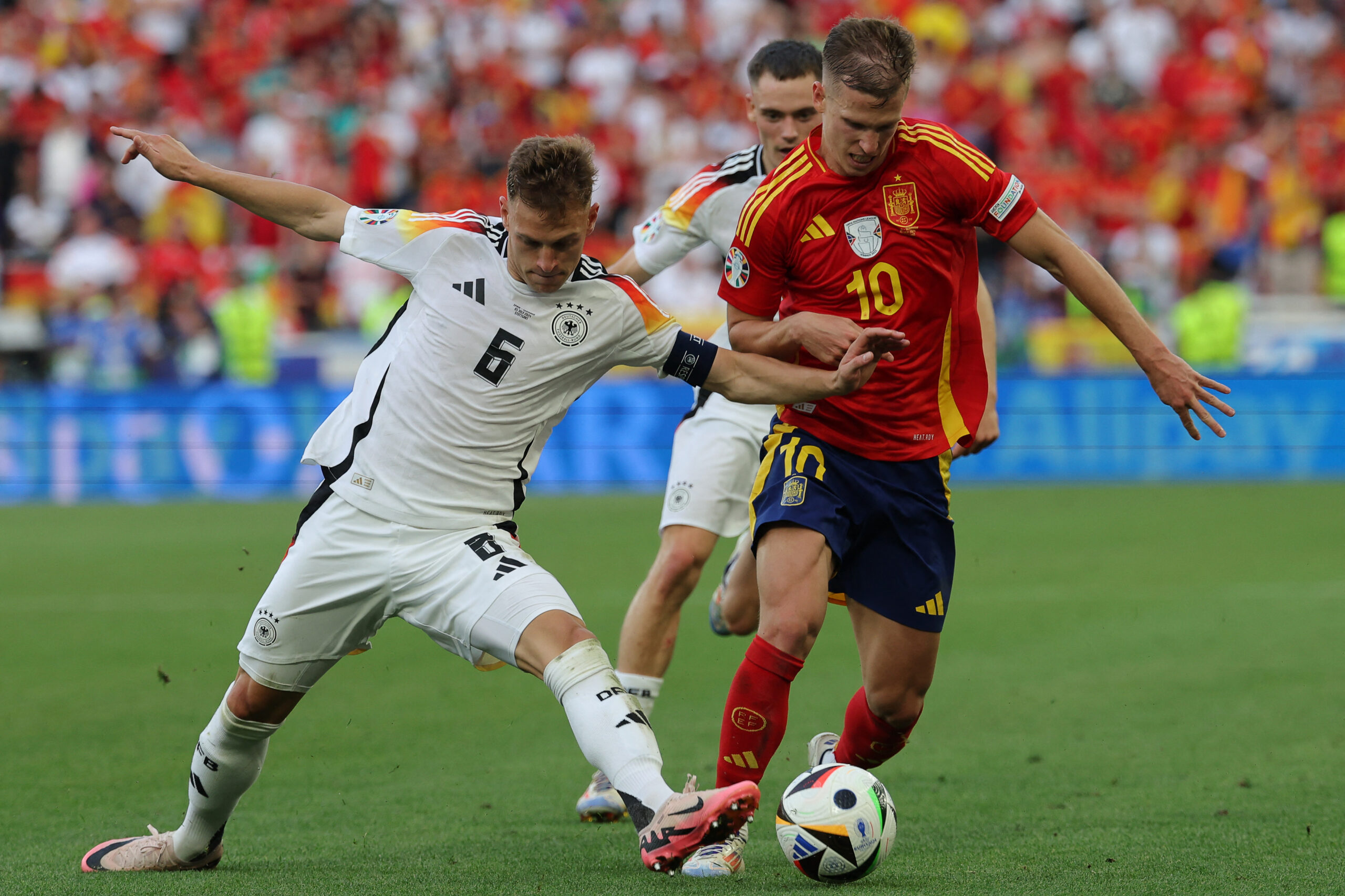 Germany's defender #06 Joshua Kimmich fights for the ball with Spain's forward #10 Daniel Olmo during the UEFA Euro 2024 quarter-final football match between Spain and Germany at the Stuttgart Arena in Stuttgart on July 5, 2024.