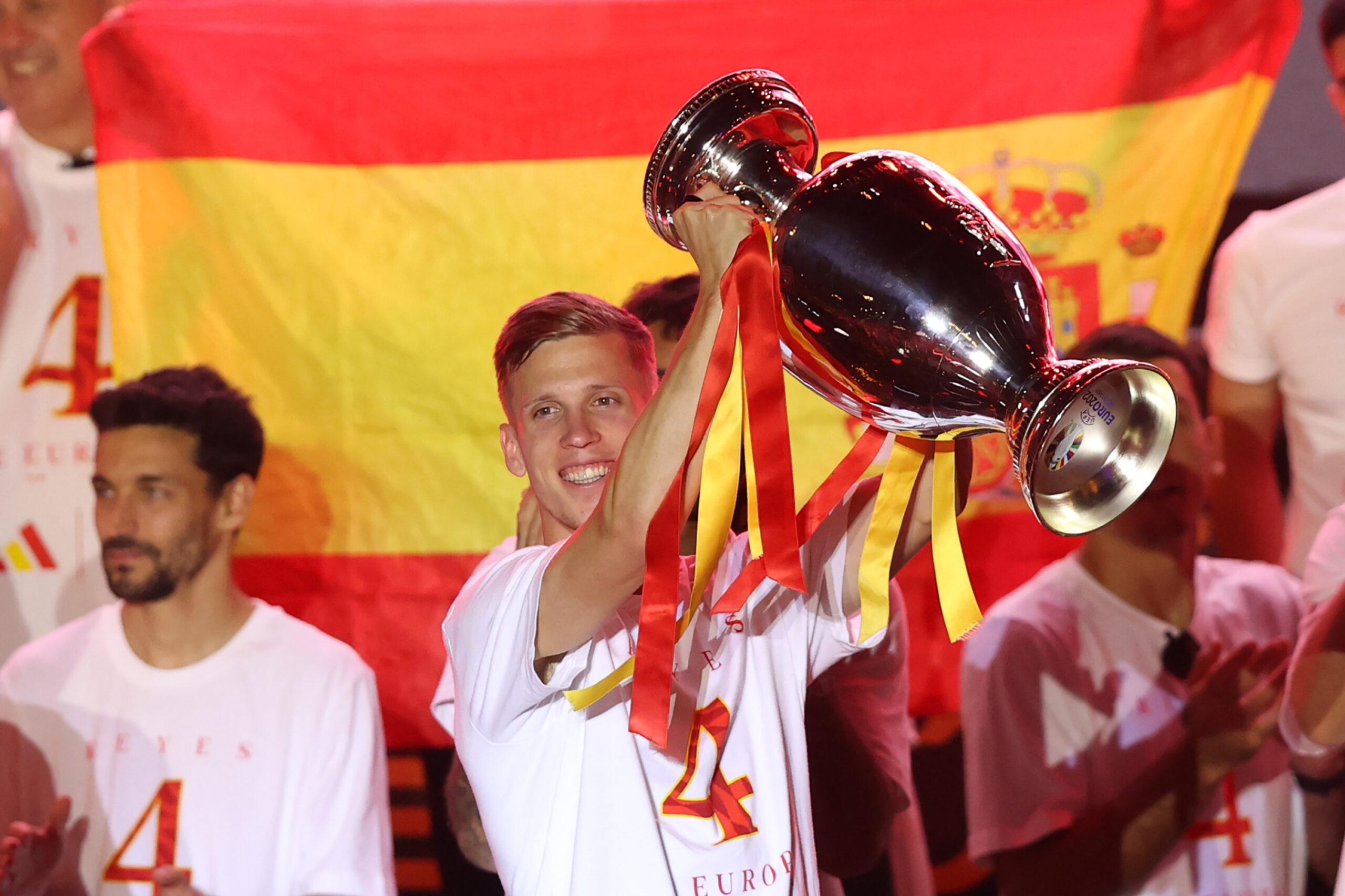 MADRID, SPAIN - JULY 15: Dani Olmo of Spain lifts the UEFA Euro 2024 Henri Delaunay Trophy during the Spain EURO 2024 Trophy Parade on July 15, 2024 in Madrid, Spain.