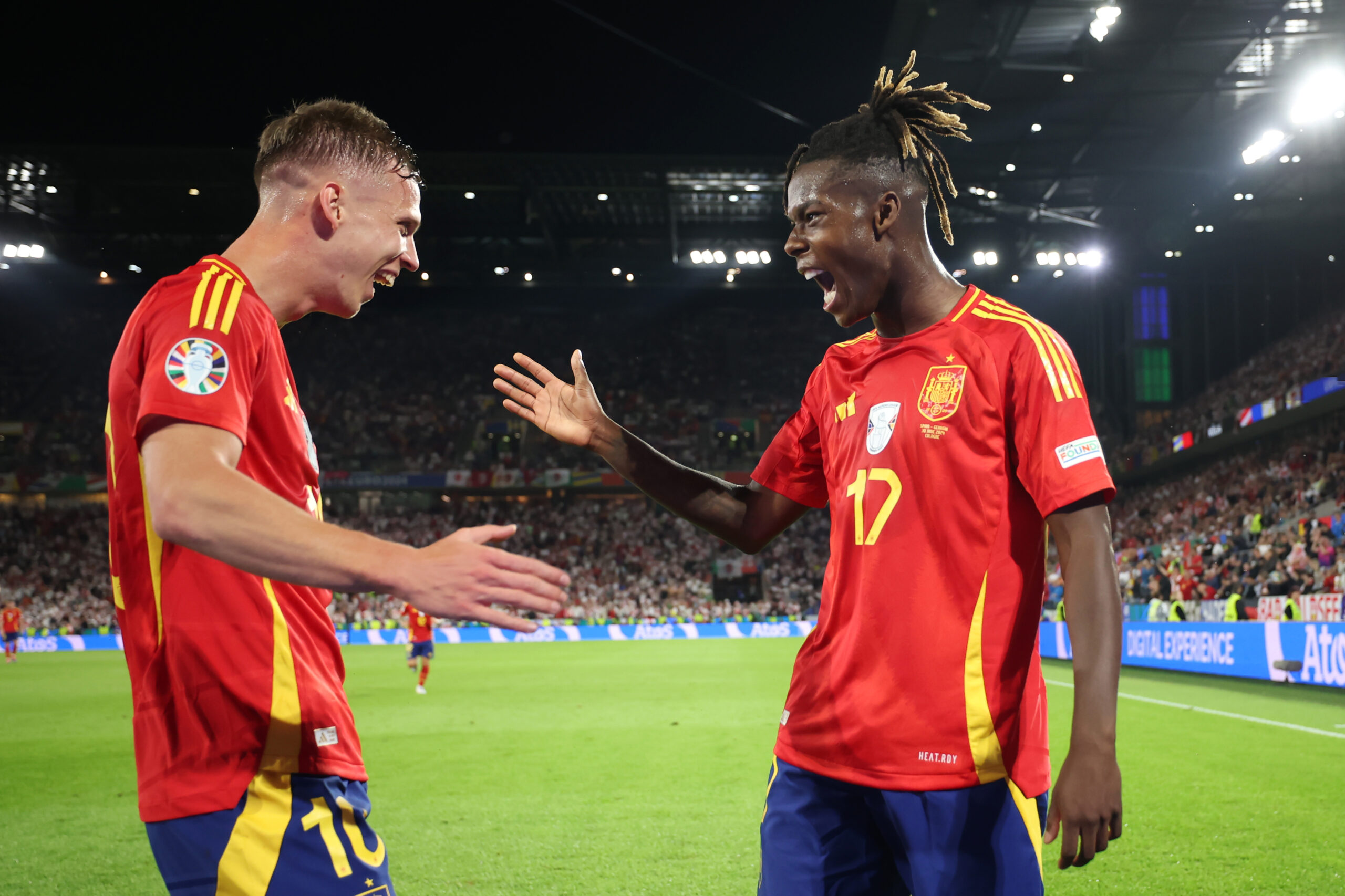 COLOGNE, GERMANY - JUNE 30: Nico Williams of Spain celebrates scoring his team's third goal with teammate Dani Olmo during the UEFA EURO 2024 round of 16 match between Spain and Georgia at Cologne Stadium on June 30, 2024 in Cologne, Germany.