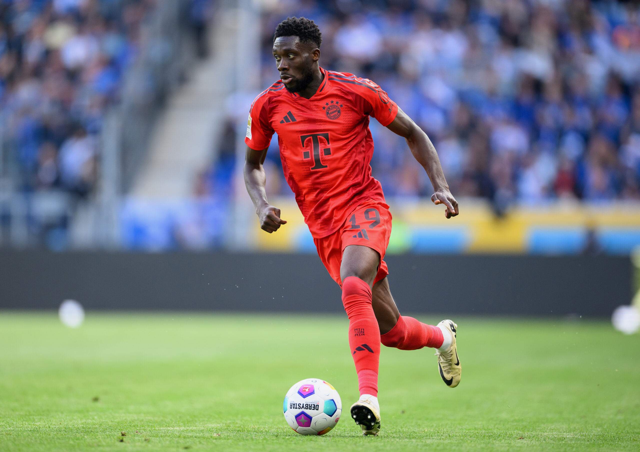 SINSHEIM, GERMANY - MAY 18: Alphonso Davies of Bayern Munich controls the ball during the Bundesliga match between TSG Hoffenheim and FC Bayern München at PreZero-Arena on May 18, 2024 in Sinsheim, Germany.