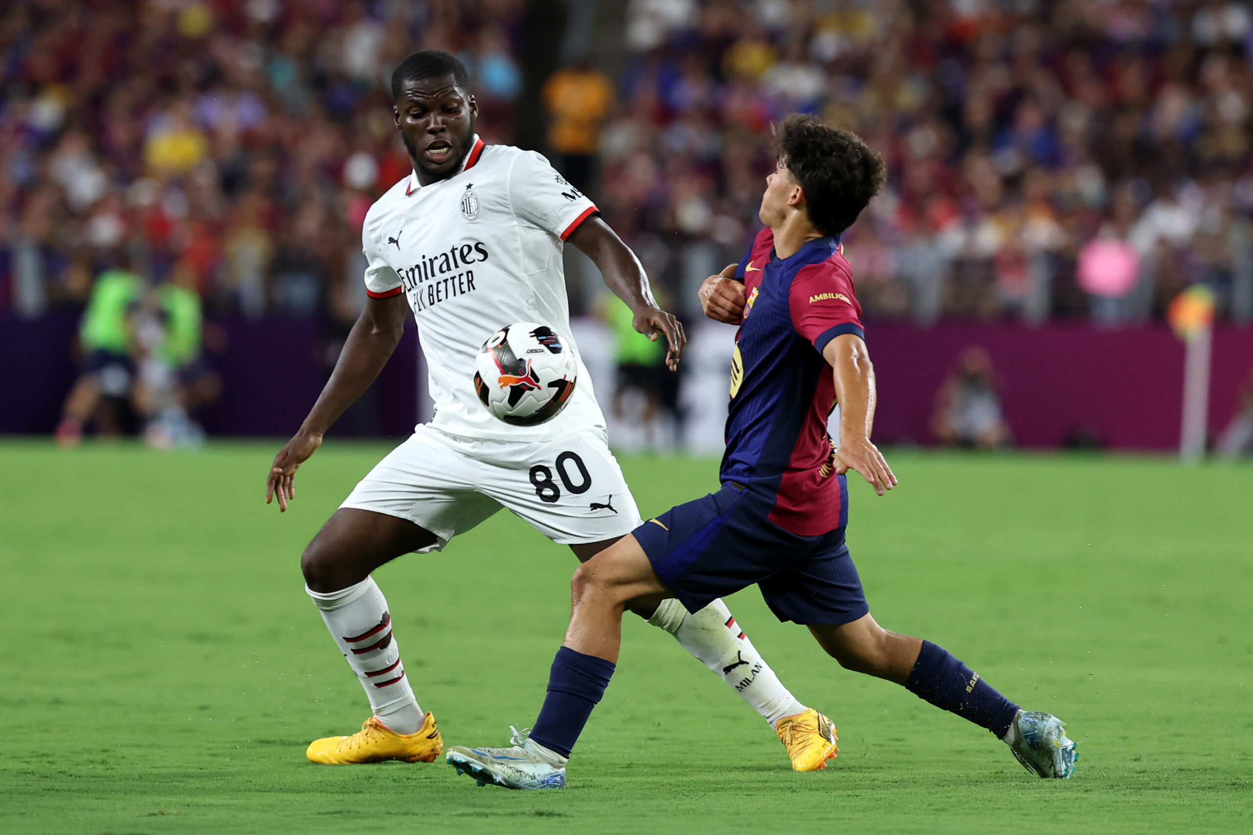 BALTIMORE, MARYLAND - AUGUST 06: Yunus Musah of AC
Milan fights for the ball with Marc Bernal of  FC Barcelona during a Pre-Season Friendly match between FC Barcelona and AC Milan at M&T Bank Stadium on August 06, 2024 in Baltimore, Maryland.